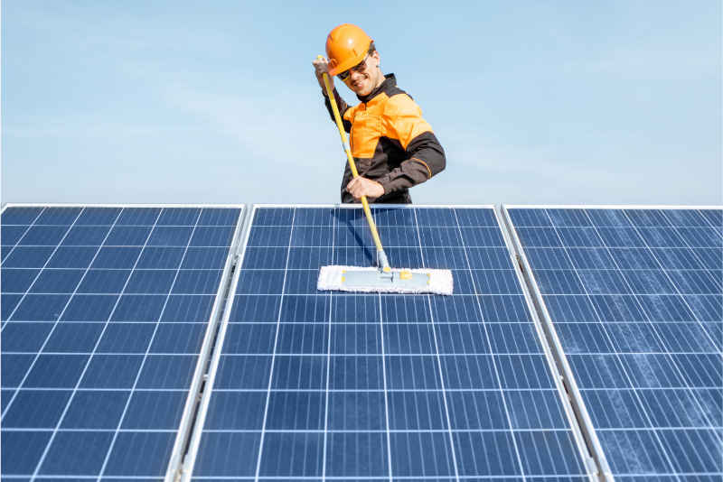 professional cleaning a solar panel